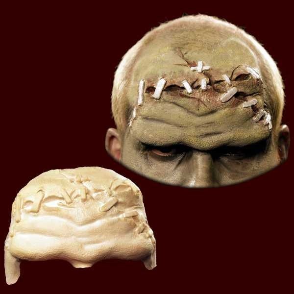 Two sculpted prosthetic face pieces showing stitched, wrinkled textures